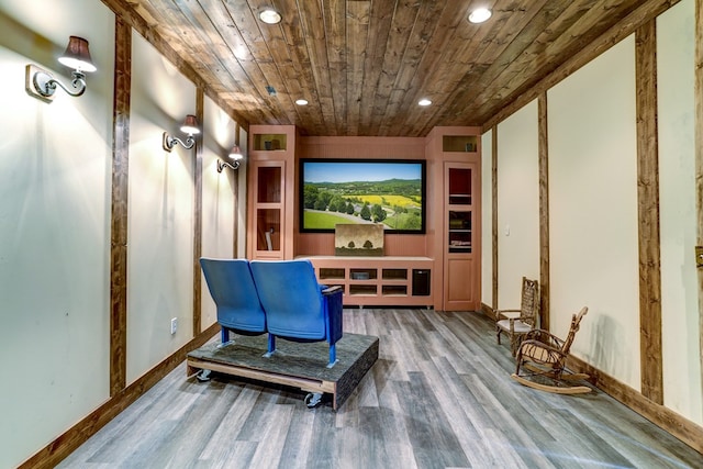 cinema room with wood-type flooring and wooden ceiling