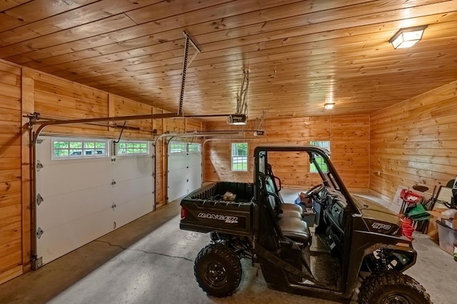 garage featuring a garage door opener, wooden ceiling, and wood walls