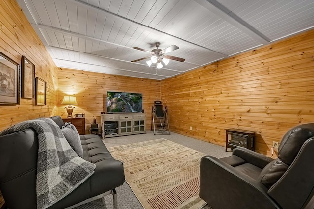 living room with carpet floors, ceiling fan, wooden ceiling, and wood walls