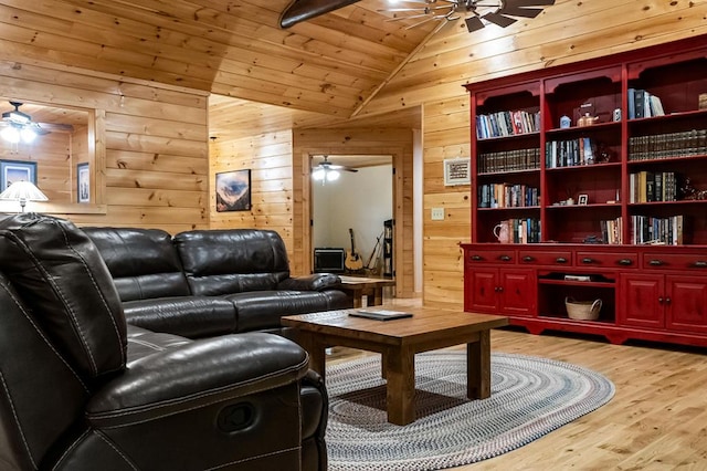 living area with light wood-type flooring, wooden walls, vaulted ceiling, and wooden ceiling