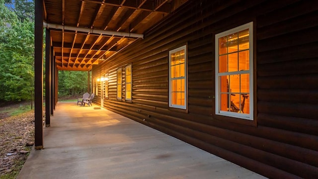 view of side of property featuring covered porch