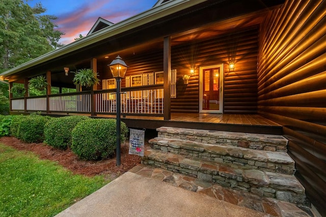 exterior entry at dusk with covered porch