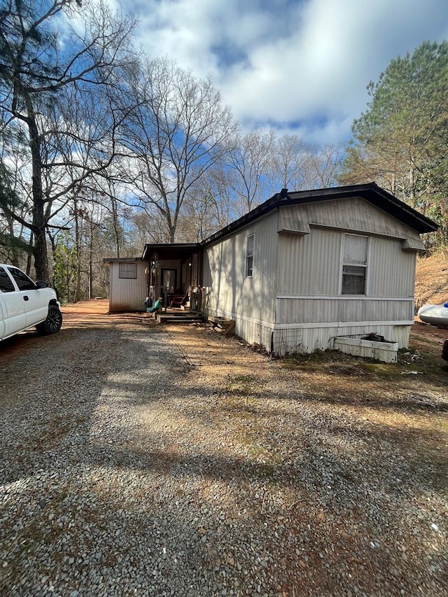 view of side of home featuring driveway