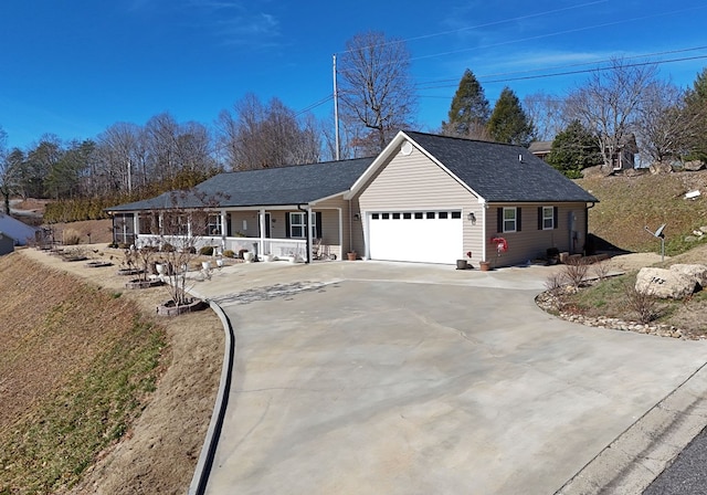 ranch-style house featuring a garage, covered porch, driveway, and a shingled roof