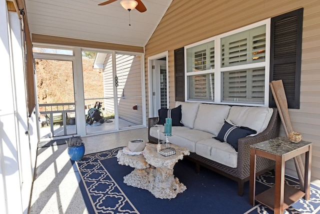 sunroom / solarium featuring lofted ceiling and ceiling fan