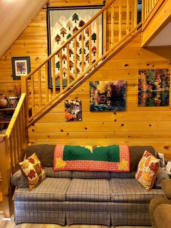 interior space with hardwood / wood-style flooring, wood walls, and vaulted ceiling