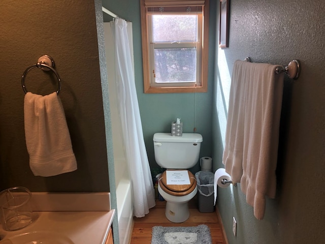 bathroom with toilet and shower / tub combo with curtain