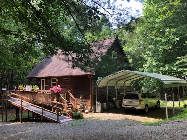 147 Blair Oaks Dr, Blairsville, GA 30512 - view of front of house with a carport, a wooden deck, and gravel driveway