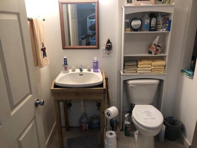 bathroom with tile patterned flooring, toilet, and sink