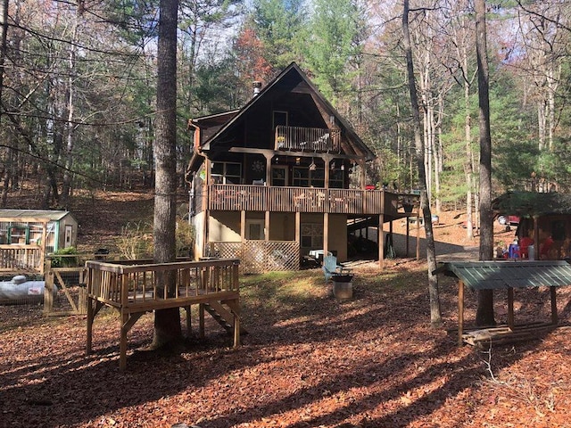 147 Blair Oaks Dr, Blairsville, GA 30512 - rear view of house with a wooden deck, stairway, and stucco siding