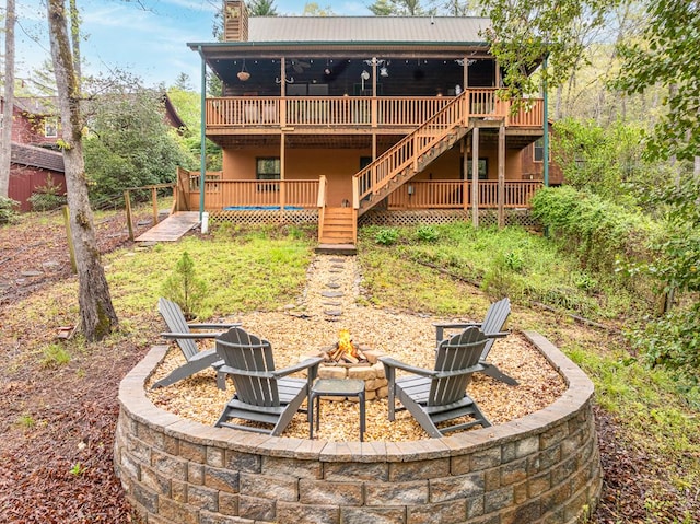 view of yard with an outdoor fire pit, stairs, and a wooden deck