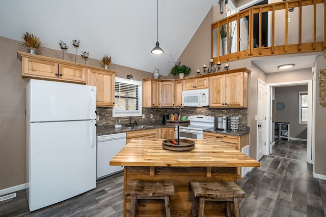 kitchen featuring visible vents, white appliances, decorative backsplash, and a sink