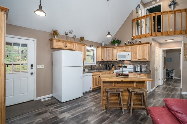 kitchen featuring a wealth of natural light, white appliances, dark wood-type flooring, and a sink