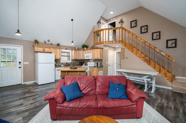 living area featuring baseboards, high vaulted ceiling, dark wood-style flooring, and stairway