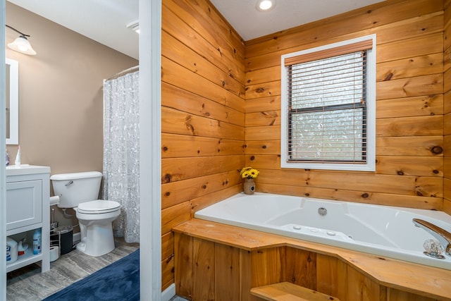 full bathroom with a shower with shower curtain, toilet, vanity, wooden walls, and a jetted tub