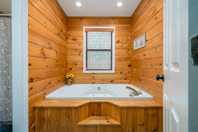 full bath with wooden walls, a garden tub, and recessed lighting