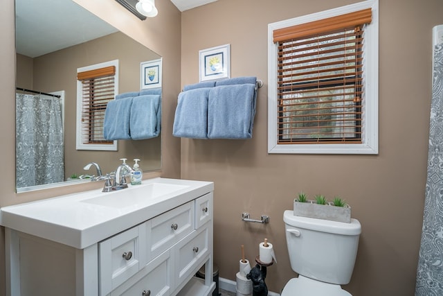 full bath featuring vanity and toilet