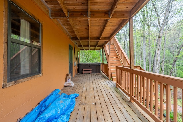 wooden terrace with stairway and a covered hot tub