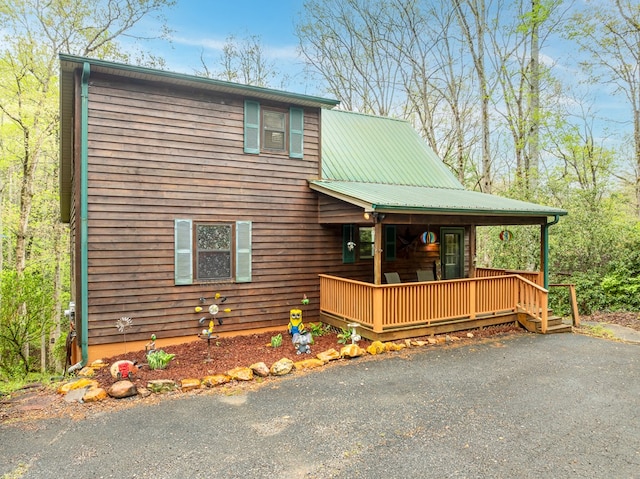 chalet / cabin with metal roof and covered porch