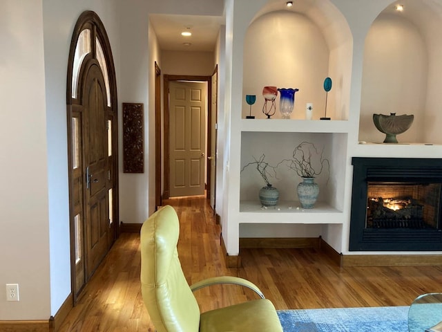 interior space featuring built in features and dark wood-type flooring