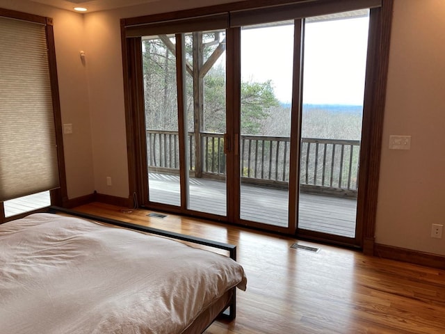 bedroom featuring access to outside and light wood-type flooring