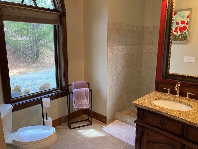 bathroom featuring vanity, tile floors, and toilet