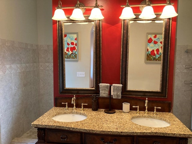 bathroom featuring dual sinks, an inviting chandelier, and vanity with extensive cabinet space