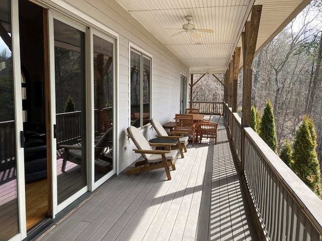 wooden deck featuring ceiling fan