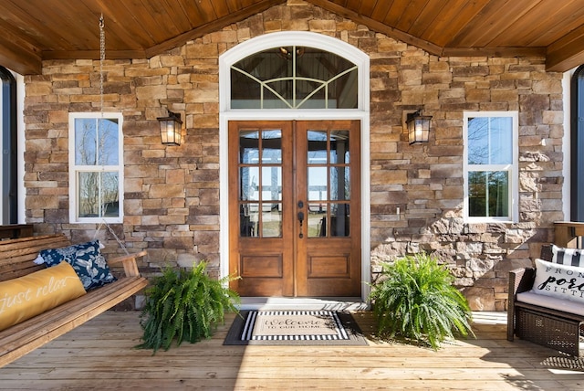 property entrance with french doors and stone siding