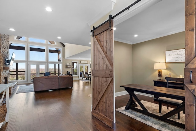 home office with dark wood-style floors, baseboards, recessed lighting, ornamental molding, and a barn door