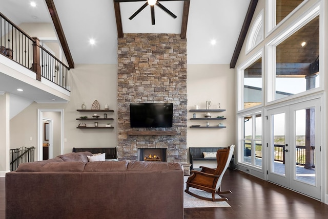 living room with ceiling fan, beam ceiling, a fireplace, dark wood-style floors, and high vaulted ceiling