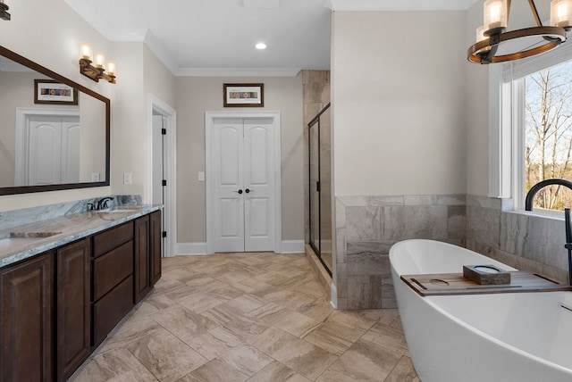 full bath featuring a shower stall, a freestanding tub, double vanity, and a sink