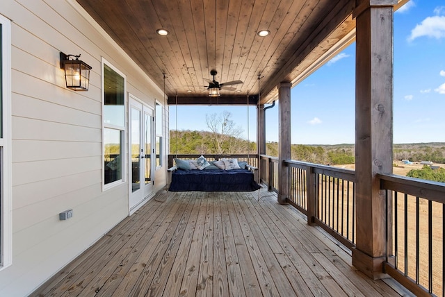 wooden terrace featuring ceiling fan