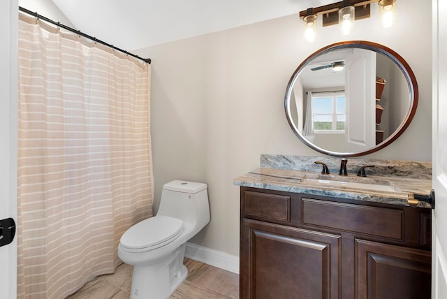 full bathroom featuring vanity, lofted ceiling, and toilet