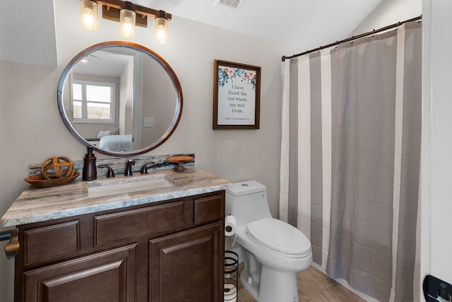 bathroom featuring visible vents, toilet, vanity, and a shower with curtain