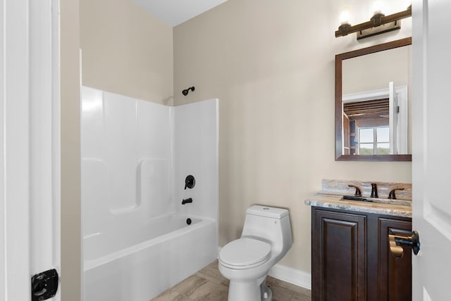 full bathroom with shower / tub combination, toilet, vanity, and baseboards