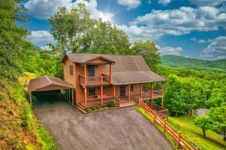 view of front facade featuring a carport and a balcony