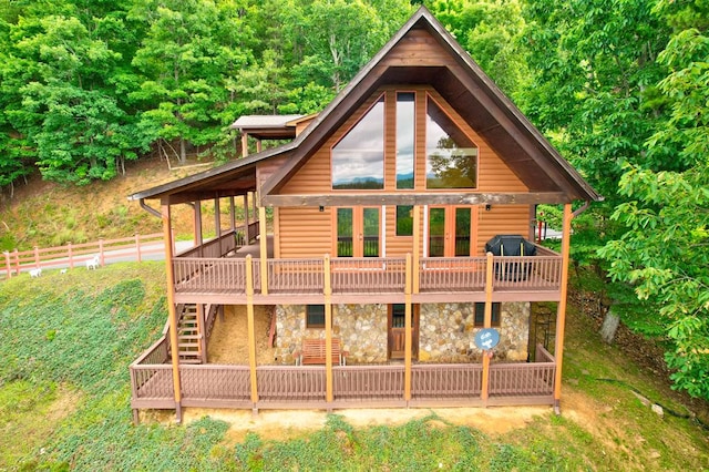 back of property with a wooden deck