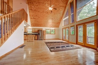 interior space with high vaulted ceiling, light hardwood / wood-style floors, ceiling fan, and french doors