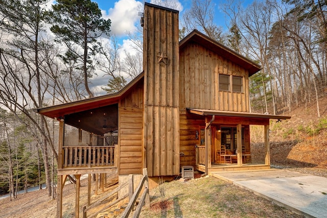 view of property exterior featuring covered porch and board and batten siding