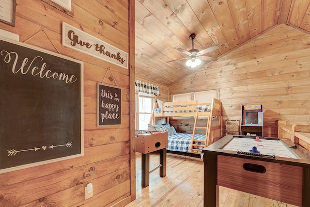 unfurnished bedroom featuring hardwood / wood-style flooring, wood walls, wood ceiling, and vaulted ceiling