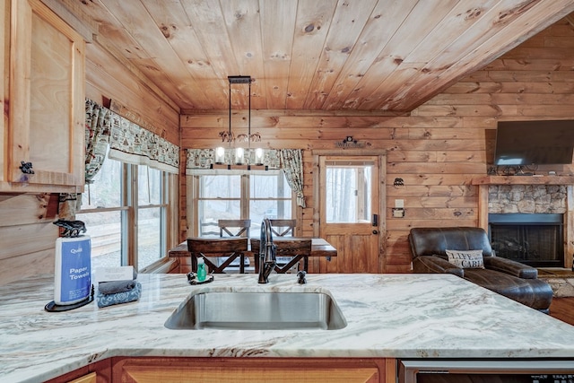 kitchen with a sink, wood ceiling, and a wealth of natural light