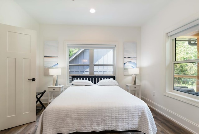 bedroom with dark hardwood / wood-style flooring