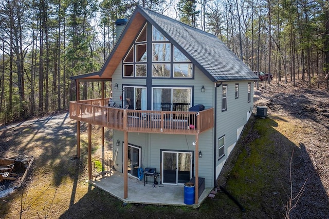 rear view of property with central air condition unit and a patio area