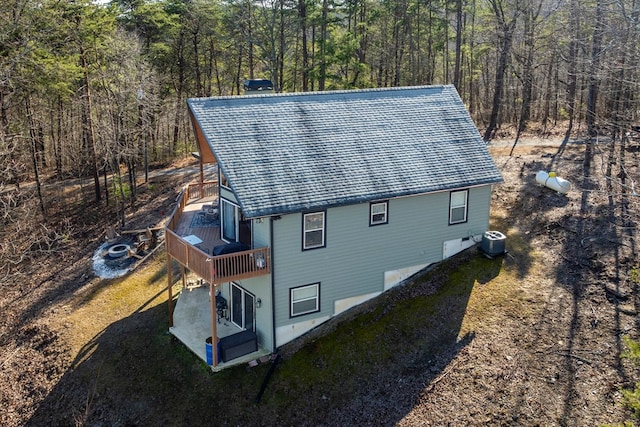 aerial view with a wooden deck, a patio, and central air condition unit