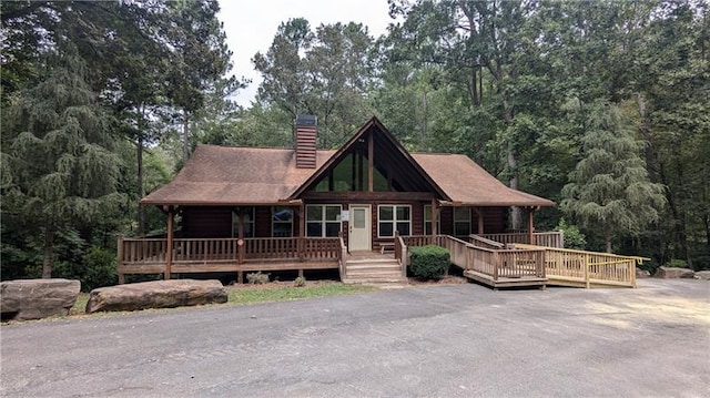 log home featuring a wooden deck