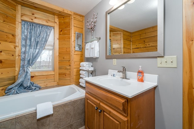 full bathroom with vanity and tiled tub