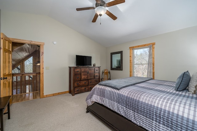 bedroom featuring baseboards, light colored carpet, ceiling fan, and vaulted ceiling