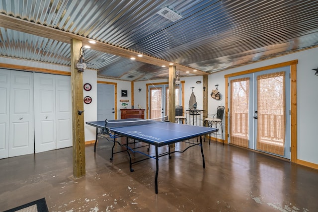 rec room featuring french doors, visible vents, and concrete floors