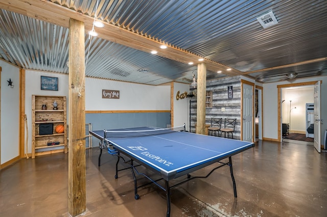 rec room with concrete flooring and baseboards